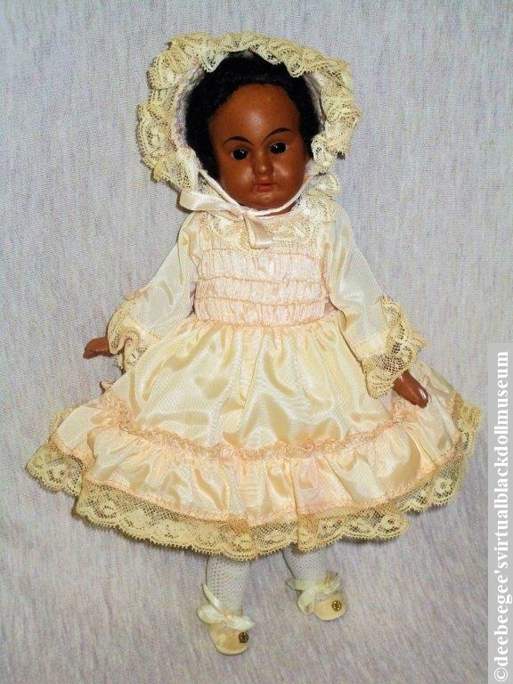 An 11-inch DEP-marked antique French or German doll from the late 19th-century to early 20th-century has a bisque socket head and full composition body. #antiqueblackdoll #DEPmarkeddoll #blackdoll